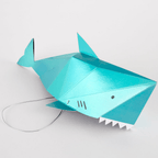 Blue shark shaped piñata with fins ocean theme decoration from Parte Haus party supply store in Bethesda MD