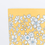 Yellow floral paper cup with white and blue flowers spring theme from Parte Haus party supply store in Bethesda MD