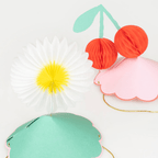White yellow daisy and red cherry paper hats spring birthday decor from Parte Haus party supply store in Bethesda MD