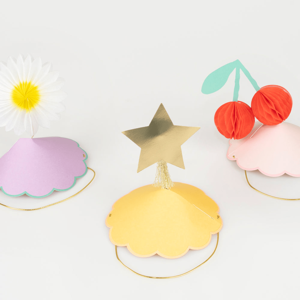 pastel paper party hats with daisy star and cherry toppers for birthday from Parte Haus party supply store in Bethesda MD