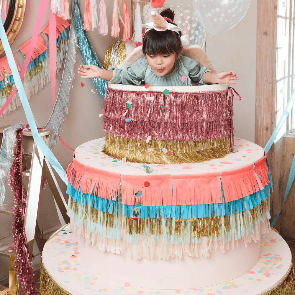 Colorful giant cake prop with fringe and confetti for birthday celebration from Parte Haus party supply store in Bethesda Maryland