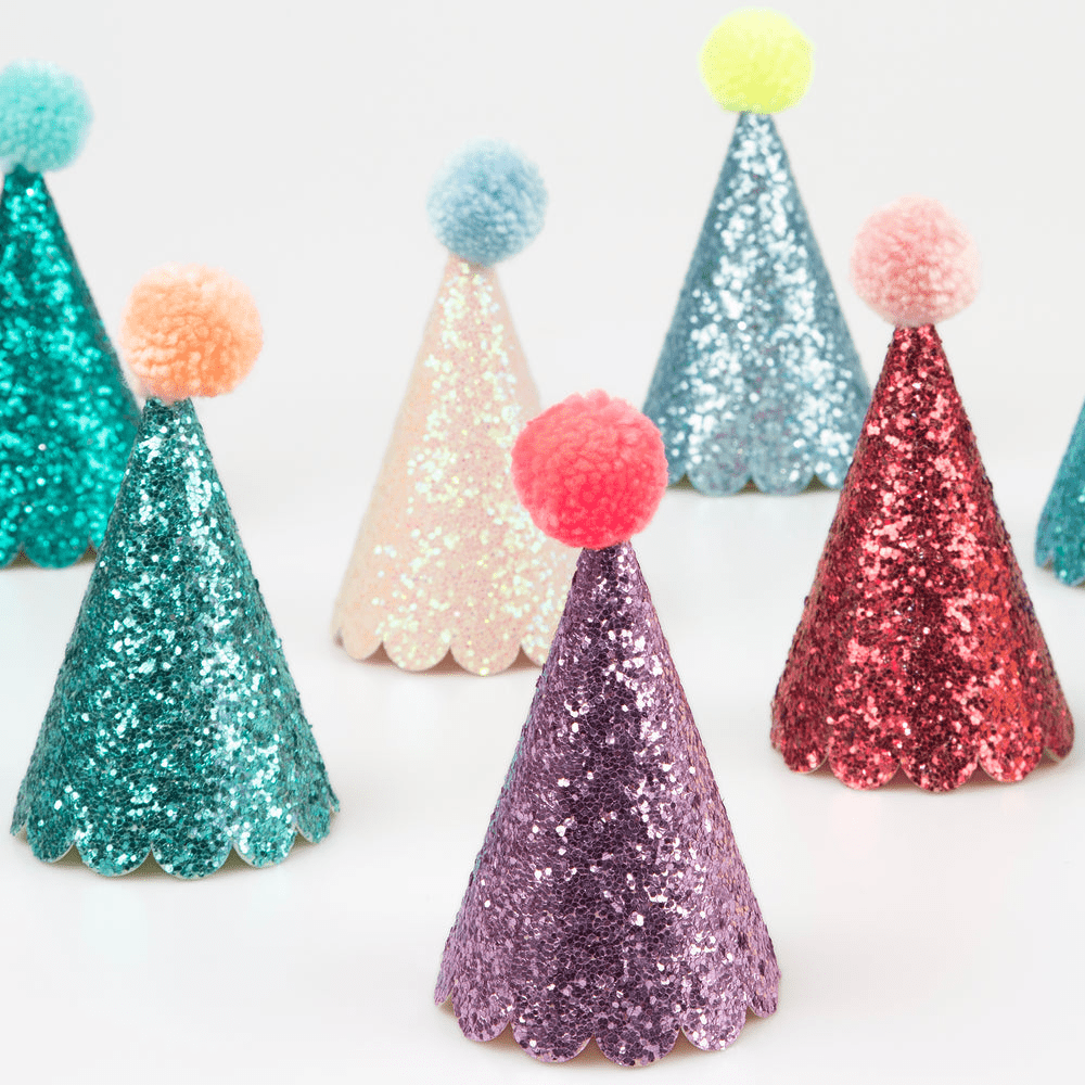 Colorful glitter cone hats with pom poms birthday theme from Parte Haus party supply store in Bethesda MD