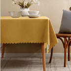 Yellow tablecloth with scalloped edges on dining table spring decor from Parte Haus party supply store in Bethesda MD.