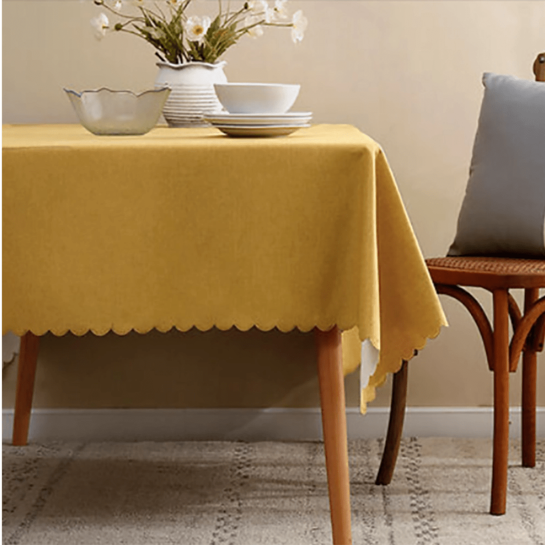 Yellow tablecloth with scalloped edges on dining table spring decor from Parte Haus party supply store in Bethesda MD.