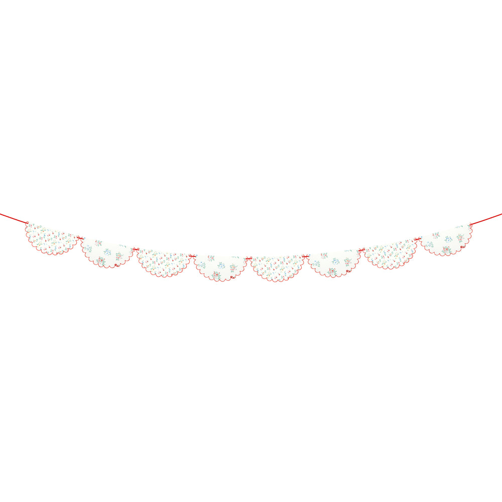 White snowflake garland with scalloped edges for winter holiday from Parte Haus party supply store in Bethesda MD.