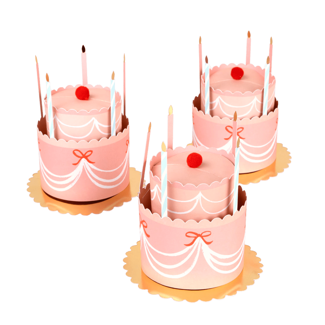 Pink birthday cake shaped favor box with candles and red pom from Parte Haus party supply store in Bethesda Maryland