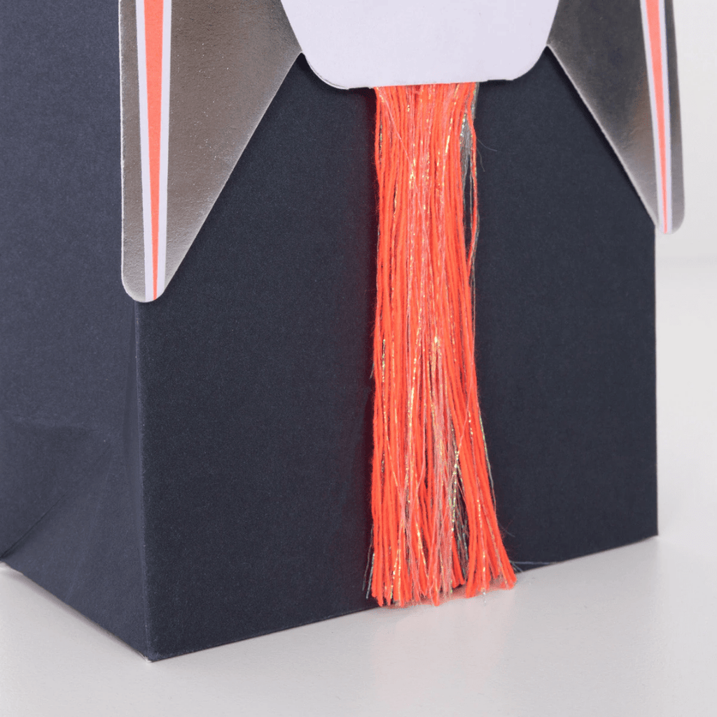 Black rocket ship treat bag with orange and gold tassel for space birthday from Parte Haus party supply store in Bethesda MD