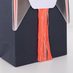 Black rocket ship treat bag with orange and gold tassel for space birthday from Parte Haus party supply store in Bethesda MD