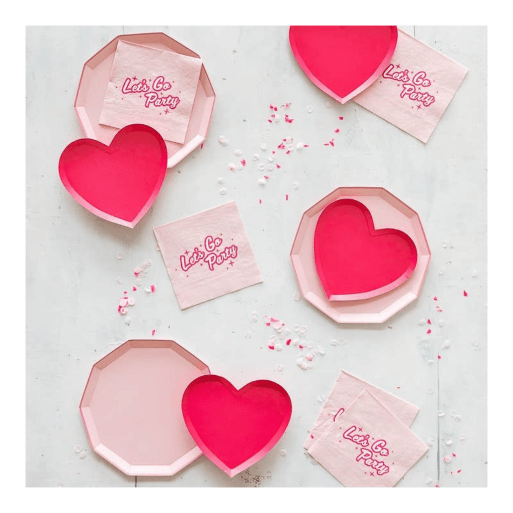 Pink heart plates and napkins with Let's Go Party text Barbie theme from Parte Haus party supply store in Bethesda Maryland