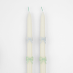Ivory taper candles with pastel blue and green bows birthday decor from Parte Haus party supply store in Bethesda MD
