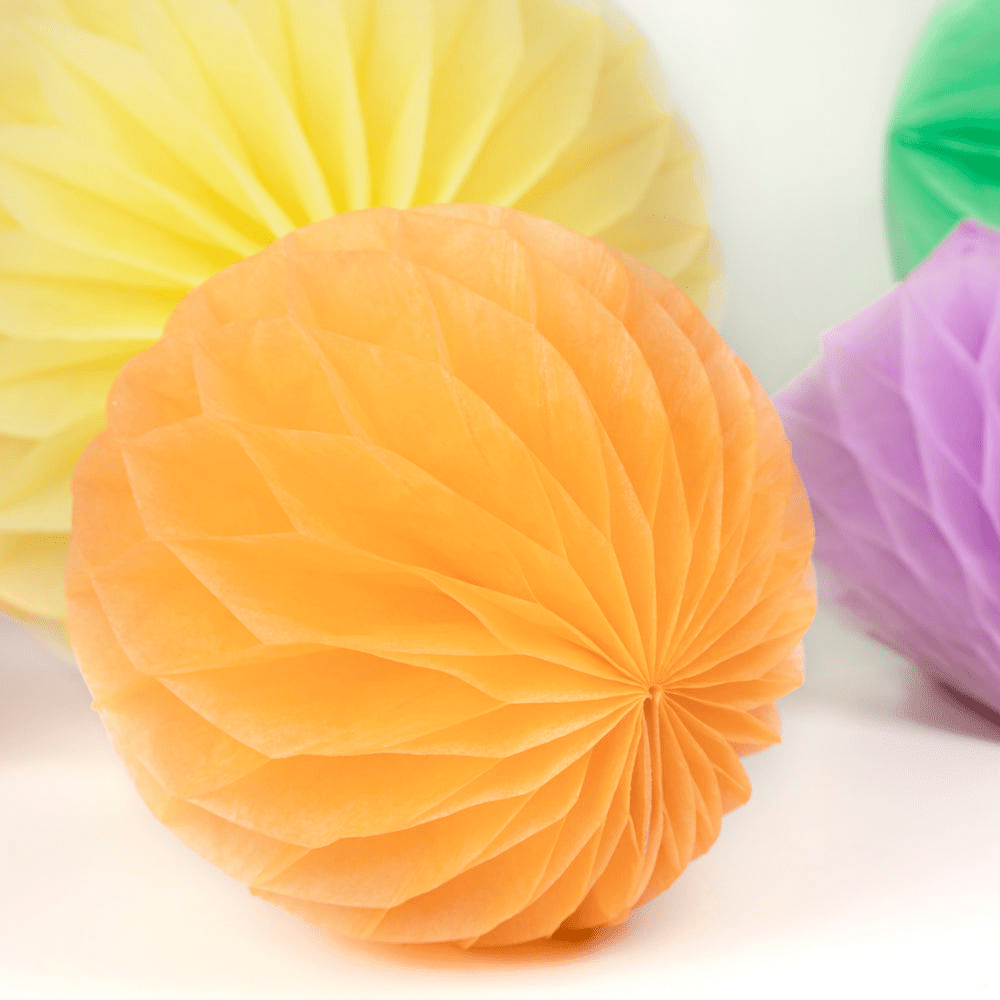 Orange yellow and purple honeycomb paper ball decorations for birthday from Parte Haus party supply store in Bethesda MD.