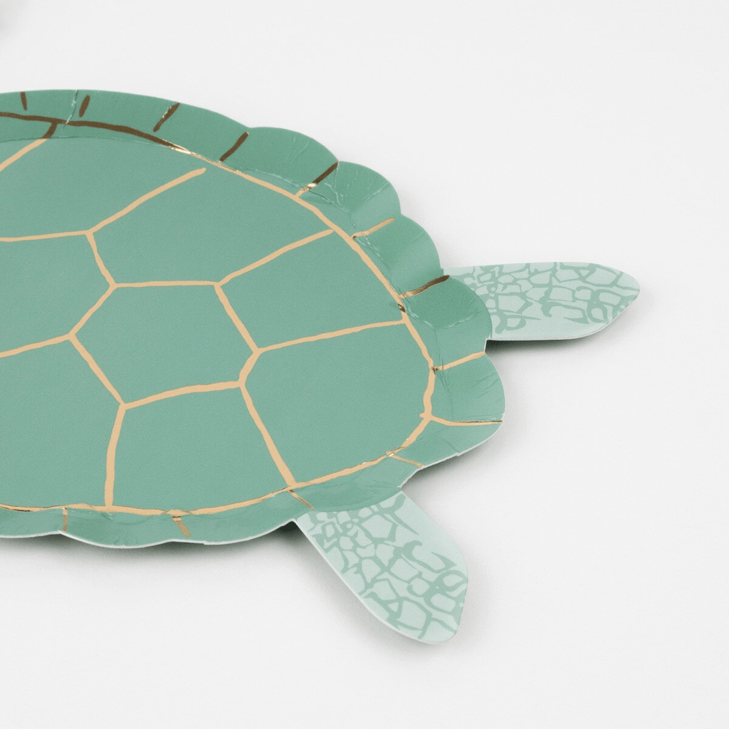 Green turtle shaped paper plate with gold accents ocean theme from Parte Haus party supply store in Bethesda MD.