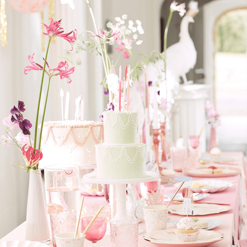 Pastel pink birthday table decor with cakes and flowers for garden celebration from Parte Haus party supply store in Bethesda MD