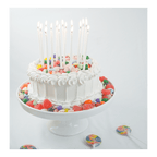 White cake with colorful candy decorations and tall birthday candles for birthday from Parte Haus party supply store in Bethesda MD