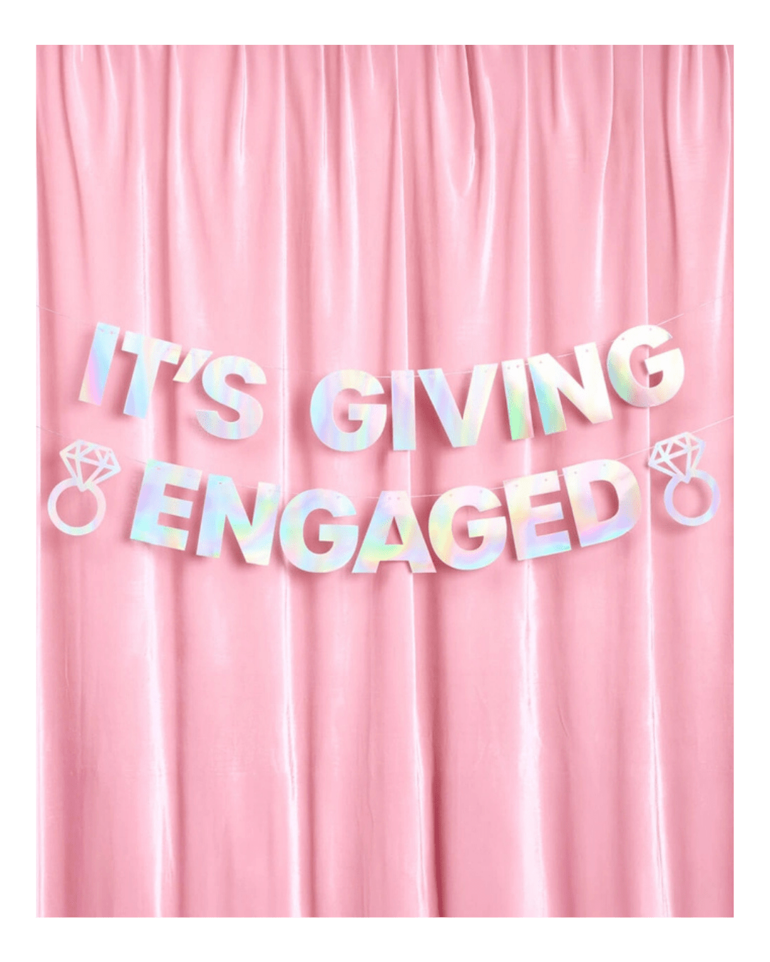 Iridescent engagement banner with diamond ring accents on pink backdrop engagement from Parte Haus party supply store in Bethesda Maryland
