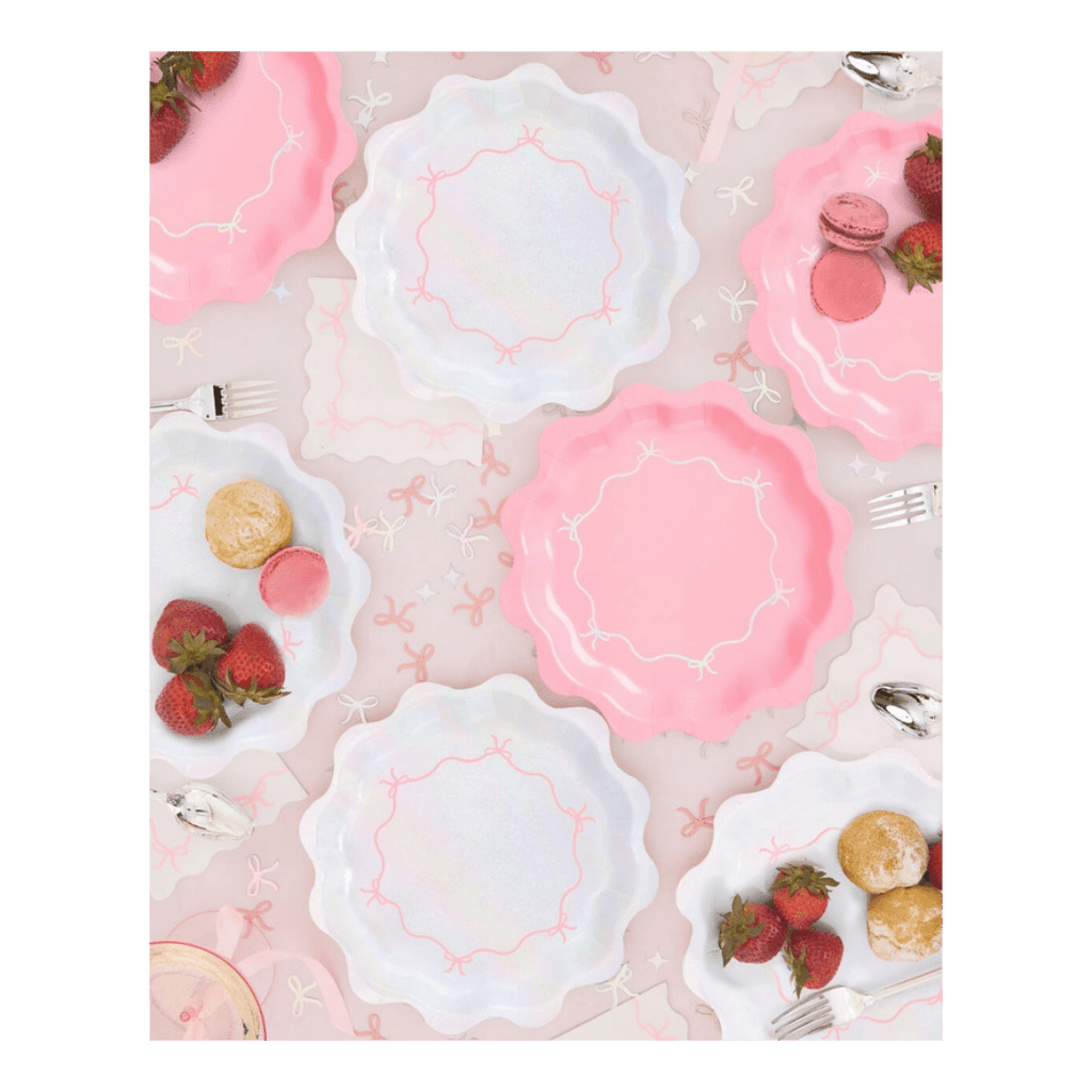 Pink and white scalloped paper plates with bows tea party theme from Parte Haus party supply store in Bethesda Maryland