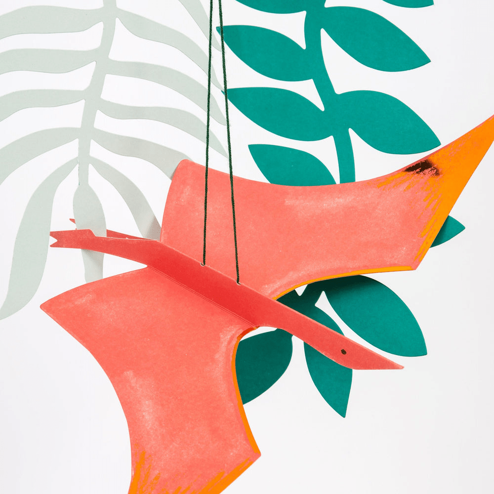 Orange dinosaur hanging decoration with green leaves for dinosaur birthday from Parte Haus party supply store in Bethesda MD