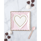 Pink and white heart-shaped paper plate set with gold trim for Valentine's Day from Parte Haus party supply store in Bethesda MD.