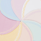 Pastel color scalloped paper plates arranged in a fan for birthday from Parte Haus party supply store in Bethesda Maryland