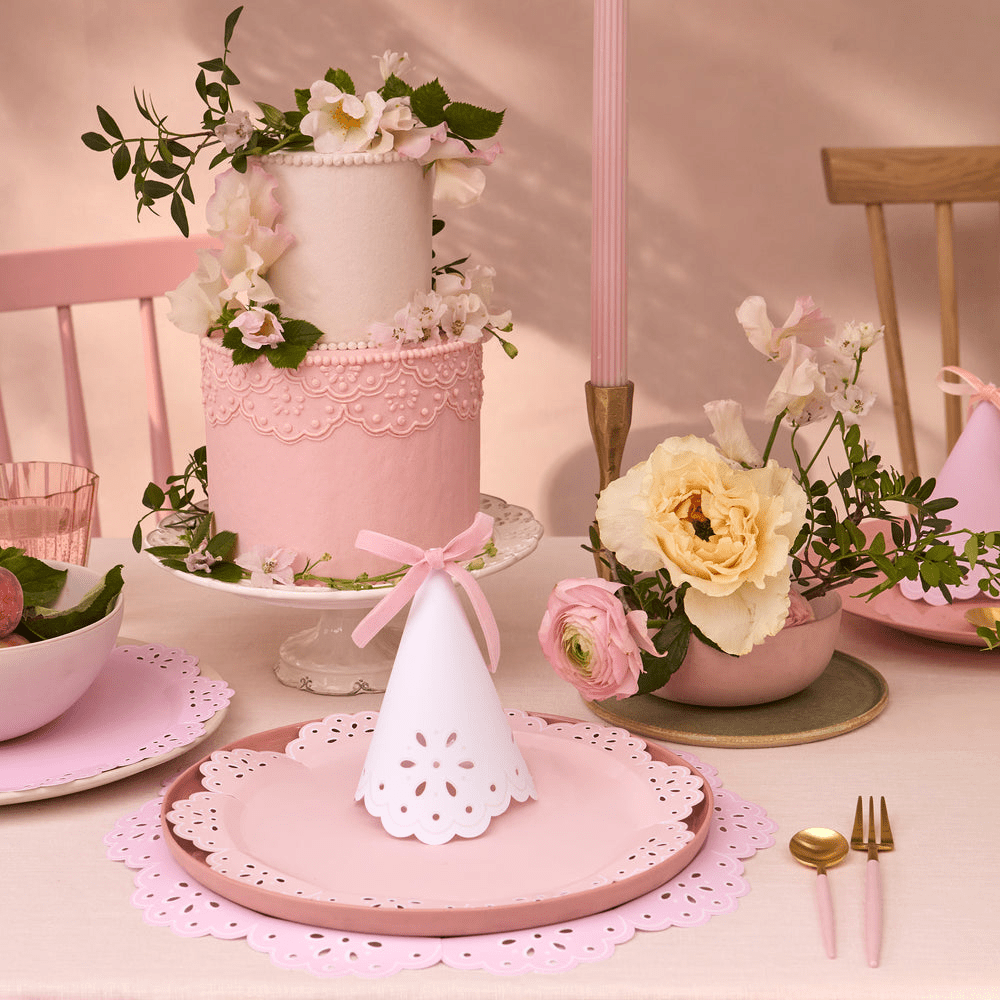 Pink floral cake and pastel party hats birthday table from Parte Haus party supply store in Bethesda MD
