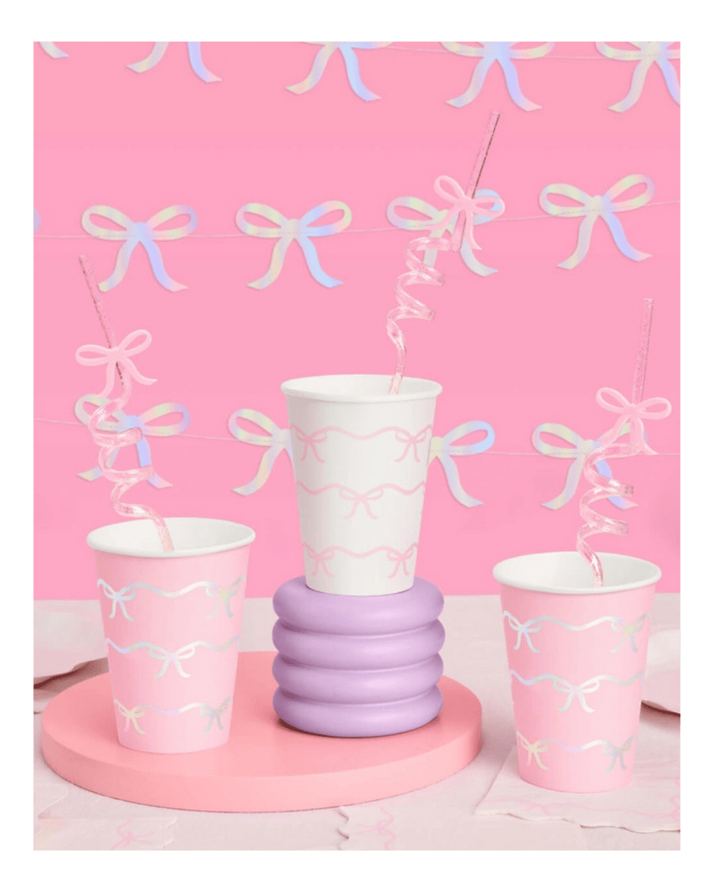 Pink and white bow paper cups with spiral straws baby shower theme from Parte Haus party supply store in Bethesda MD.
