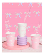 Pink and white bow paper cups with spiral straws baby shower theme from Parte Haus party supply store in Bethesda MD.