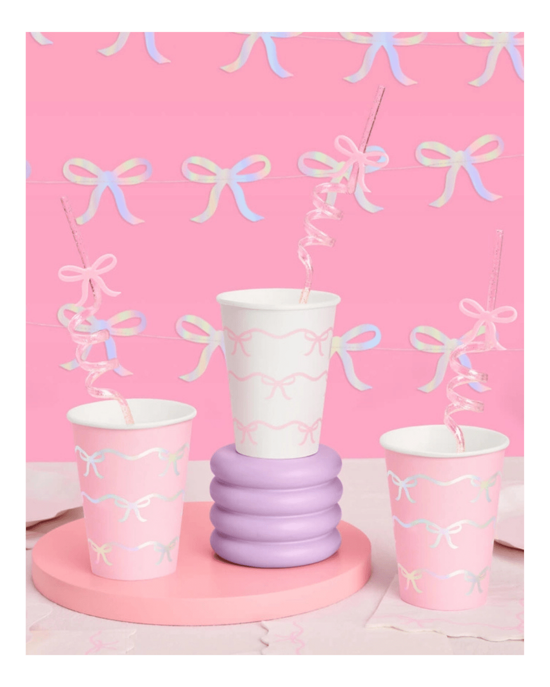 Pink and white bow paper cups with spiral straws baby shower theme from Parte Haus party supply store in Bethesda MD.