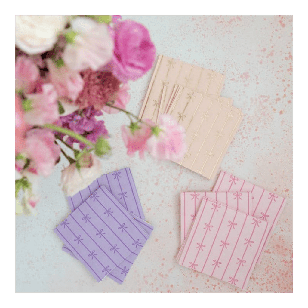 Pink purple and beige napkins with bow patterns for spring celebration from Parte Haus party supply store in Bethesda Maryland