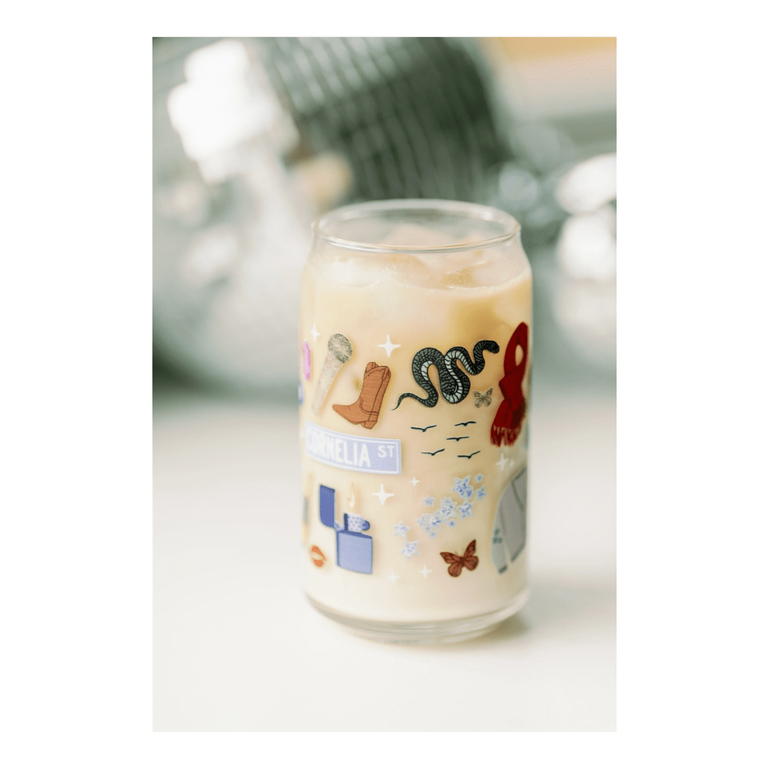 Multicolor custom glass cup with fun sticker icons for celebration theme from Parte Haus party supply store in Bethesda MD.