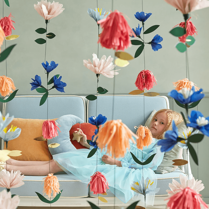 Multicolor floral garland paper decorations with a girl in pastel room spring theme from Parte Haus party supply store in Bethesda Maryland.