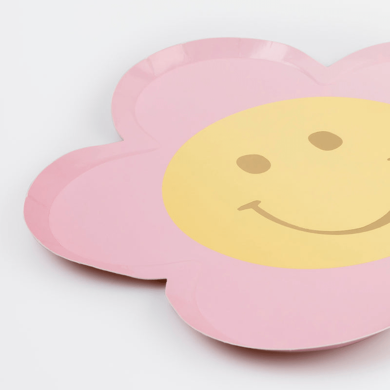 Pink flower shaped paper plate with a yellow smiley face birthday theme from Parte Haus party supply store in Bethesda Maryland
