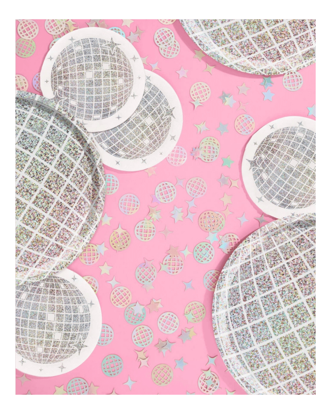 Silver disco ball plates and confetti on pink background disco theme from Parte Haus party supply store in Bethesda MD.