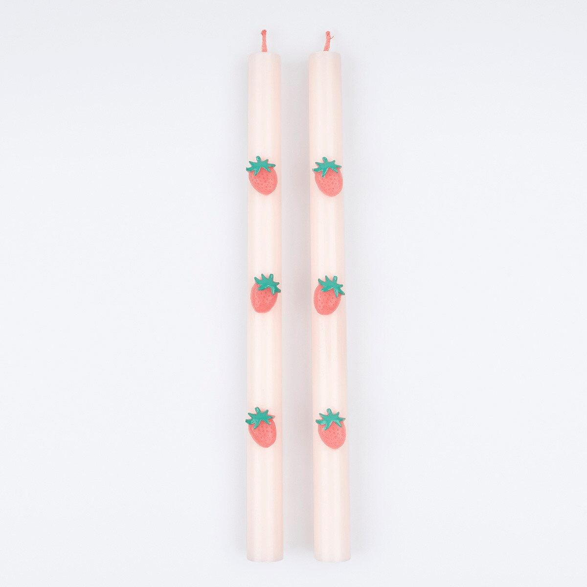 Pink strawberry taper candles with strawberry details summer theme from Parte Haus party supply store in Bethesda MD.