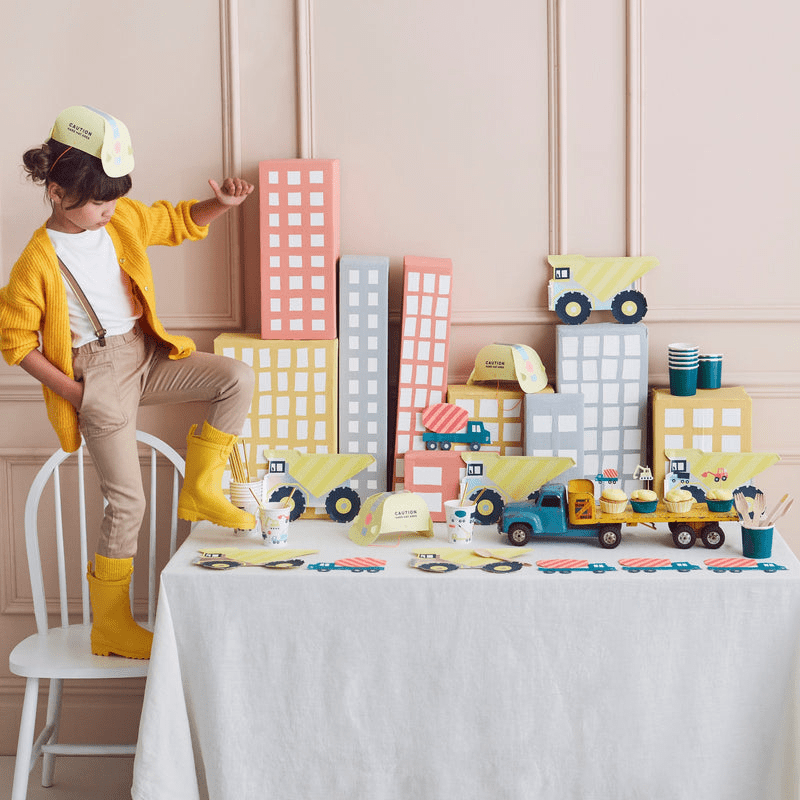 Yellow construction truck dessert table decor with building blocks and hard hat birthday theme from Parte Haus party supply store in Bethesda MD