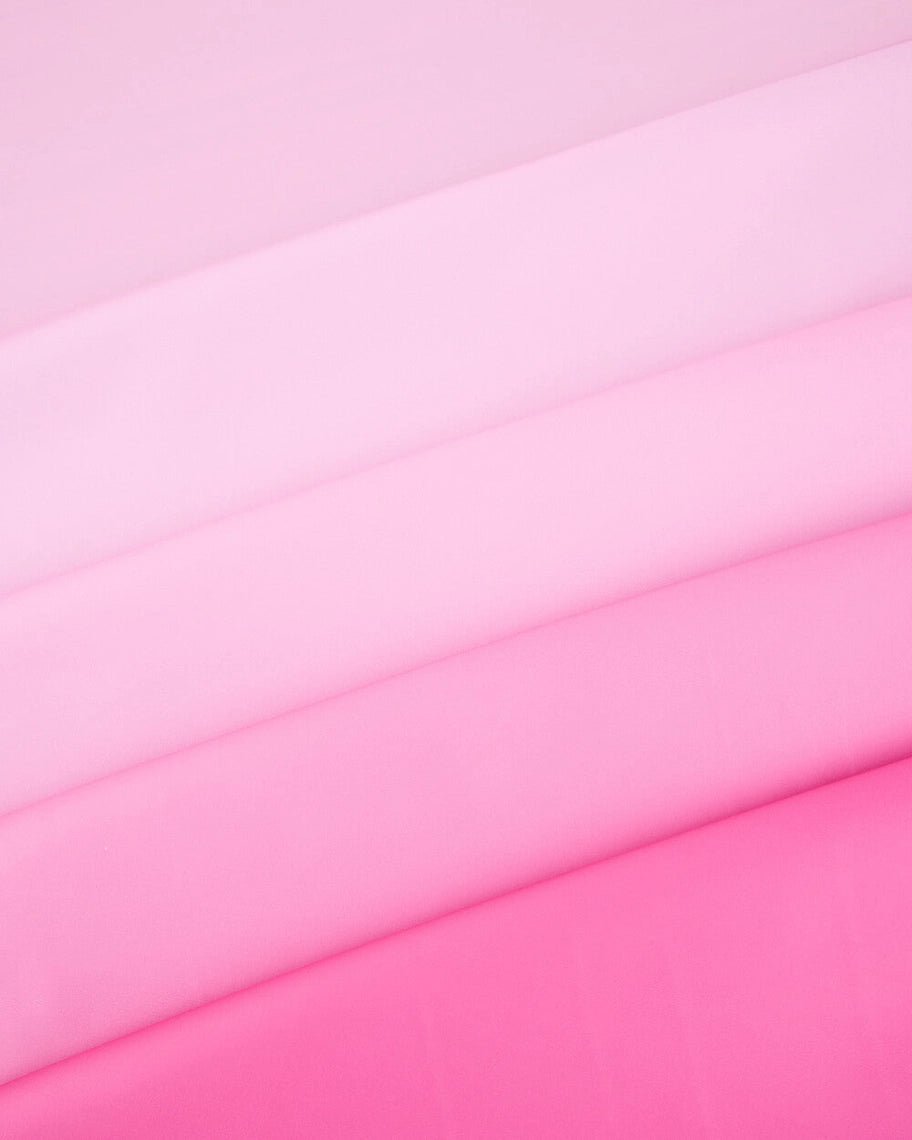 Pink ombre table cover fabric folded for birthday from Parte Haus party supply store in Bethesda Maryland