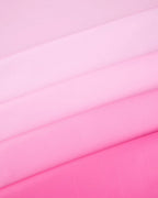Pink ombre table cover fabric folded for birthday from Parte Haus party supply store in Bethesda Maryland