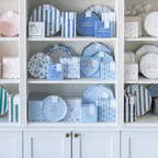 Blue and pink paper plates and napkins birthday and baby shower decor on shelves from Parte Haus party supply store in Bethesda Maryland