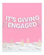 Iridescent engagement banner with diamond ring shapes engagement celebration decor from Parte Haus party supply store in Bethesda Maryland