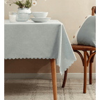 Light grey tablecloth with scalloped edge on dining table for home event decor from Parte Haus party supply store in Bethesda MD