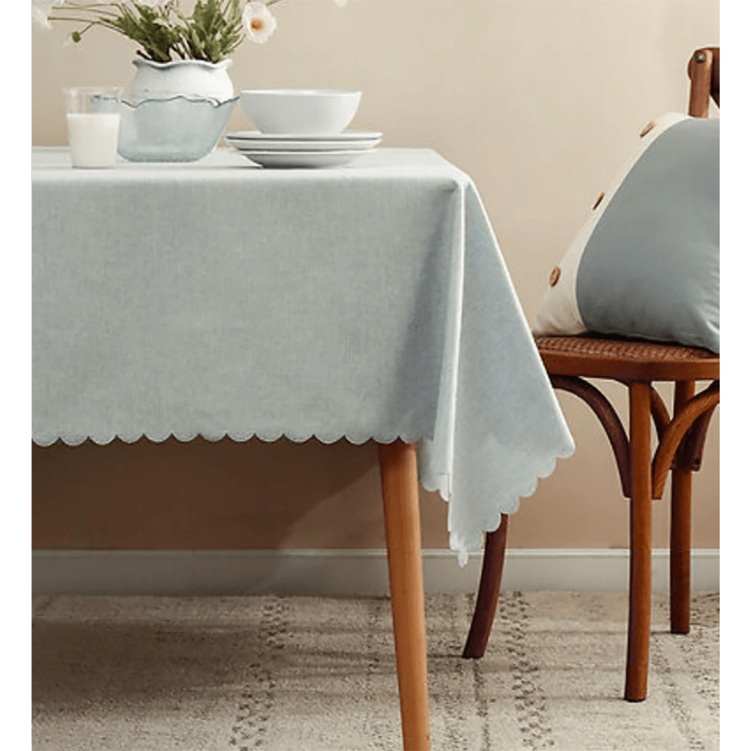 Light grey tablecloth with scalloped edge on dining table for home event decor from Parte Haus party supply store in Bethesda MD