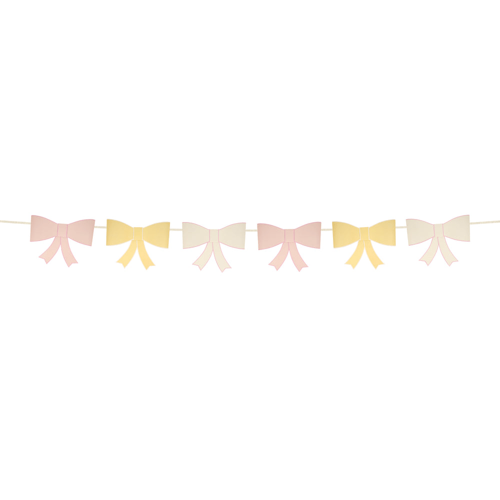 Pastel pink yellow and cream bow garland banner for birthday celebration from Parte Haus party supply store in Bethesda Maryland