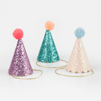 Purple teal and pink glitter party hats with pom poms birthday theme from Parte Haus party supply store in Bethesda MD