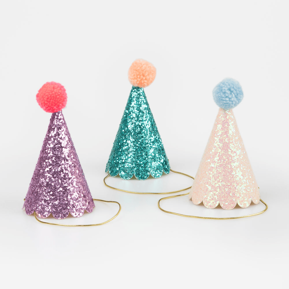 Purple teal and pink glitter party hats with pom poms birthday theme from Parte Haus party supply store in Bethesda MD