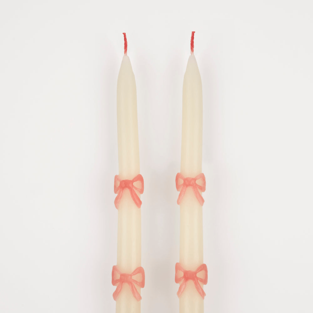 Ivory taper candles with pink bow design elegant decor from Parte Haus party supply store in Bethesda Maryland