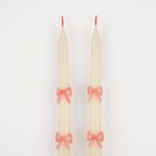 Ivory taper candles with pink bow design elegant decor from Parte Haus party supply store in Bethesda Maryland