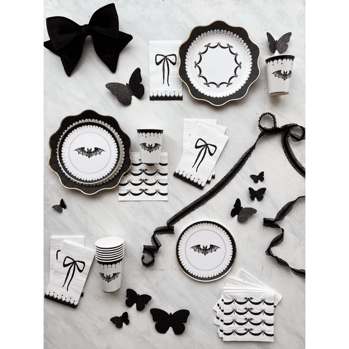 Black and white gothic Halloween plates napkins and cups with bat and bow designs from Parte Haus party supply store in Bethesda Maryland