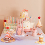 Pastel birthday cake table with party hats candles and decorations birthday theme from Parte Haus party supply store in Bethesda Maryland