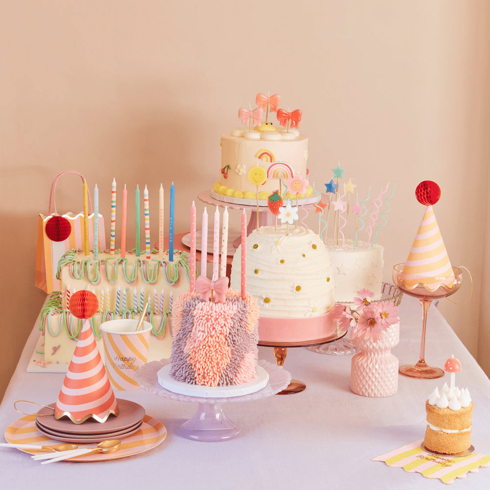 Pastel birthday cake table with party hats candles and decorations birthday theme from Parte Haus party supply store in Bethesda Maryland