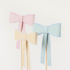 Pastel pink blue and yellow paper bow decorations on sticks birthday theme from Parte Haus party supply store in Bethesda MD.