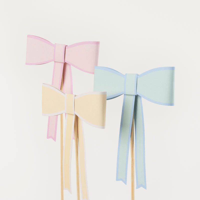 Pastel pink blue and yellow paper bow decorations on sticks birthday theme from Parte Haus party supply store in Bethesda MD.